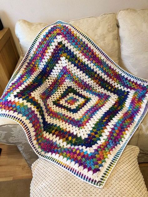 CROCHET PATTERNS & TUTORIALS | I made this baby blanket for my sister's little daughter, look how beautiful this print is, very delicate white combined with variegated yarn | Facebook Crochet Blanket Border, Granny Blanket, Rainbow Yarn, Square Crochet Pattern, Crochet Blanket Designs, Crochet Granny Square Blanket, Granny Square Blanket, Variegated Yarn, Square Blanket