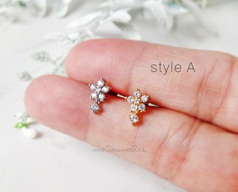 * Mini Flower with Gem Drop Stud Ear Piercing, 16G For earlobe and cartilage helix earring. * Materials : Post - 316L Surgical Steel , Flower with Gem Drop - Copper and AAA Cubic Zirconia * Closure type : Screw Ball back * Dimensions; Flower #A : 6 x 10 mm Flower #B : 7 x 12 mm * Bar length : 6 mm * Bar thickness : 16 gauge (1.2 mm) * Ball back size : 16G / 4 mm **Measurements are an approximation. Size, shape and color can vary slightly from above dimensions.**   ............................... Mini Stud Earrings, Stone Earrings Studs, Gold Earrings For Kids, Small Earrings Gold, Gold Earrings Models, Diamond Earrings Design, Minimalist Earrings Gold, Helix Earring, Rose Gold Earrings Studs