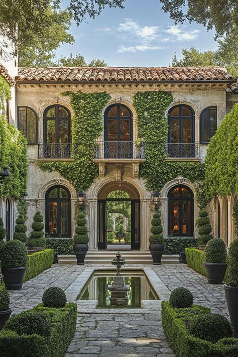 Mediterranean villa with ivy-covered walls and lush courtyard. Embark on a whirlwind tour of luxurious abodes where opulence meets whimsy, leaving you green with envy and ideas for your next home upgrade. Italy House Italian Villa, Traditional Courtyard House, Covered Courtyard, Courtyard Homes, Mediterranean Houses, Art Genres, Hacienda Style Homes, Story Stone, Stone Chimney