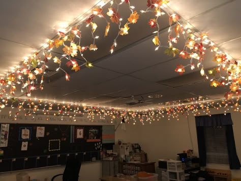 Fall lights for my classroom. Icicle lights+dismembered leaf garlands+hot glue gun Classroom Christmas Decorations Ceiling, Classroom Ceiling Christmas Decor, Ceiling Decorations Classroom, Led Lights Classroom Decor, Classroom Decor Lights, Lighting For Classroom, Lighting In Classrooms, Ceiling Crafts For Classroom, School Ceiling Decorations