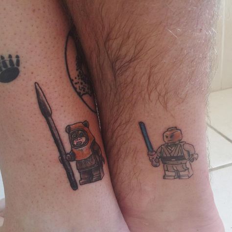 Family matching Star Wars Lego tattoos. Corey got Mace Windu (lightsaber needs to be touched up with purple) and I got Wicket the Ewok.… Star Wars Band Tattoo, Matching Star Wars Tattoo Best Friends, Matching Star Wars Tattoo, Star Wars Matching Tattoos, Lego Star Wars Tattoo, Star Wars Couple Tattoo, Ewok Tattoo, Vader Tattoo, Star Wars Tattoo Sleeve