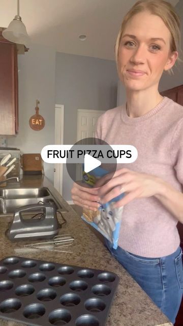 Andrea on Instagram: "Fruit Pizza Cups

✨cookbook in my bio✨

Take Pre made sugar cookie dough cubes and put them into a mini muffin pan. Bake per package directions. When finished cooking take a spoon or shot glass and place them inside to form a cup (video before this one showing how). Leave the cookies in the pan and let cool. I set them in the freezer for about ten minutes.

In a separate bowl add:
1 softened block of cream cheese 
2 TBSPS butter softened 
1 1/4 cup powdered sugar
1 tsp vanilla 
Mix well
Set in fridge 

Take out cookie cups and fill with your icing and top with chopped fruit

Enjoy!!" Fruit Pizza Sugar Cookie Cups, Fruit Pizza Mini Tarts, How To Make A Fruit Pizza, Fruit Cookie Cups, Mini Yogurt Parfait Cups Party, Fruit Pizza Cups Mini, Mini Sugar Cookie Fruit Tarts, Healthy Potluck Desserts, Cookie Muffin Cups