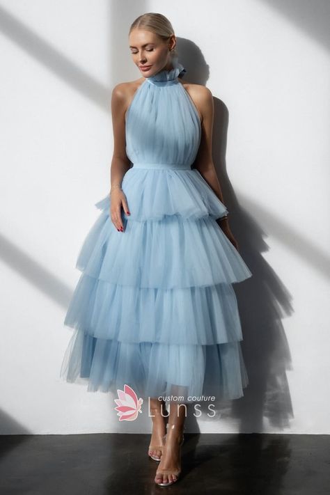 Backless tiered blue tulle ankle length maxi dress! Airy tulle above poly lining shapes this wedding party dress that has high halter neck and open back. High empire waist tops the tiered maxi skirt. Pair yours with your favorite high heels.