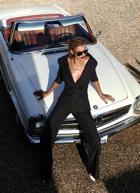 Posing on a convertible, Kelly Rohrbach models pinstriped pantsuit from Monse with Michael Kors sunglasses and Jimmy Choo heels Mode Poses, Car Editorial, Classic Car Photoshoot, Kelly Rohrbach, Cow Boys, Car Poses, Alfred Stieglitz, Model Pose, Jimmy Choo Heels