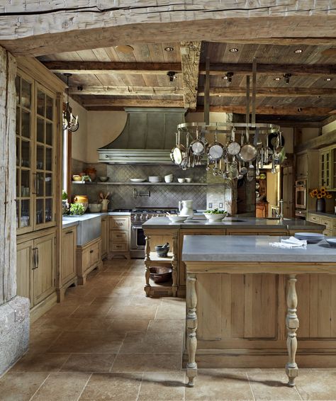 The gourmet kitchen includes cabinets capped with concrete and zinc countertops, semi-commercial appliances, and a custom stainless-steel hood and back wall. #concretecounter #rusticbeams #barnboardceiling #limestonetilefloor #farmkitchen #kitchenisland #traditionalarchitecture #frenchnormandystyle #farmhouse #rusticdesign Old English Kitchen, English Kitchens, French Kitchen, French Farmhouse, French Country House, French House, Beautiful Kitchens, Kitchen Styling, Rustic Kitchen