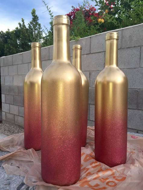 Step 1: Get some wine bottles from a restaurant (or your own collection)  Step 2: Clean off labels  Step 3: Spray with metallic gold spray paint  Step 4: Spray 2 layers of pink glitter spray paint. :-)     Enjoy! Metallic Gold Spray Paint, Wine Bottle Craft, Wine Bottle Project, Wedding Jars, Cowgirl Christmas, Wine Bottle Ideas, Mother Bear, Diy Spray Paint, Budget Crafts