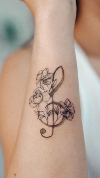 Music And Faith Tattoo, Music Symbol Tattoo Girly, Music Tattoo Ribs, Flowers With Music Notes Tattoos, G Music Note Tattoo, Wrist Music Tattoos, Peace And Music Tattoo, Music Tattoo With Flowers, Music Wrist Tattoos For Women