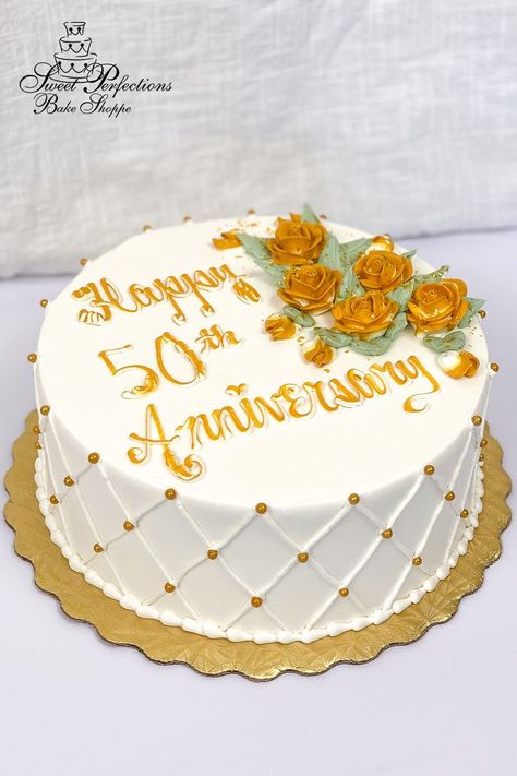 Celebrate a half century of love with cake especially designed for a golden anniversary. You choose your size and flavors, and we’ll ice it in our signature vanilla buttercream, add buttercream quilting and gold pearls on the side, then pipe a spray of gold roses with a touch of edible glitter next to your inscription. This simple design idea is available to order for your party right off our website! Minimum seven days’ notice; local pickup only. #spbakeshoppe Wedding Anniversary Cake Design Simple, Simple Anniversary Cakes, Anniversary Cake Designs, 50th Anniversary Cakes, Custom Desserts, Gold Roses, Wedding Anniversary Cake, Golden Anniversary, Edible Glitter