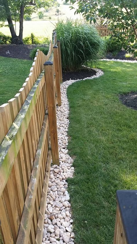 River Rock Along Fence Line, Landscaping Around Walkway Front Yards, Fenced Front Yard Landscaping, Rock Barrier Landscaping, Outside Air Conditioner Landscaping, River Rock Backyard Landscaping, Landscape Ideas Against Fence, Under Fence Gap Ideas Backyard, Around Fence Landscaping