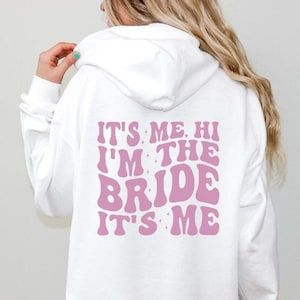 It's Me Hi I'm The Bride It's Me Hoodie, Bride Hoodie, Wedding Hoodie, Bridal Shirt, Bride Aesthetic, Bride Gift, Trendy Bride, Bride 2024 Wedding Hoodie, Aesthetic Bride, Bride Aesthetic, Bride 2024, Bride Hoodie, Bridal Shirts, Trendy Bride, Brides Babes, Bridal Party Shirts