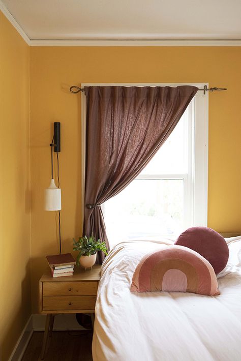 A playful and vibrant color pairing in the bedroom ensures always waking up on the bright side! Yellow Shout | 0935 walls and modern mauve accessories create a sweet vibe in this space. Muted Yellow Bedroom, Mauve Yellow Bedroom, Lavender And Mustard Bedroom, Mustard Yellow Bedroom Walls, Purple And Mustard Bedding, Yellow Walls Bedroom, Purple Yellow Room, Light Mustard Wall Color, Yellow And Purple Room