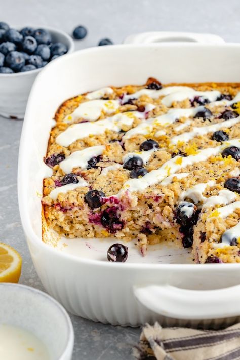 Beautiful lemon blueberry baked oatmeal made with fresh lemon juice & zest and naturally sweetened with pure maple syrup. This lemon baked oatmeal is gluten free & dairy free with bursts of fresh blueberries and poppy seeds in every bite. Drizzle with a homemade lemon yogurt topping for the perfect breakfast treat! #oatmeal #bakedoatmeal #blueberries #healthybreakfast #easter #brunch Ambitious Kitchen Recipes, Blueberry Baked Oatmeal, Baked Oatmeal Cups, Champagne Cocktails, Ambitious Kitchen, Baked Oatmeal Recipes, Lemon Poppyseed Muffins, Oatmeal Cups, Lemon Yogurt