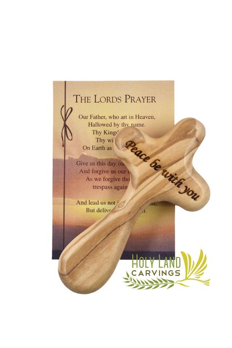 "Hand Holding Cross made of Olive Wood In the Holy Land, Laser Engraved with \"Peace Be With You\". This cross is better known as the 'comfort cross' as holding the soft wood offers one solace and over time the cross will develop its own natural patina adding hues and richness. Sometimes just holding this cross will bring comfort.  Each Cross comes with a gift bag and Our Father Prayer Card. Give this cross as a Christening, Baptism, or a confirmation gift or for any occasion.  Product Dimension Palm Cross, Our Father Prayer, Olive Wood Cross, The Lord's Prayer, Cross Gift, Lord's Prayer, The Holy Land, The Lords Prayer, Wood Crosses