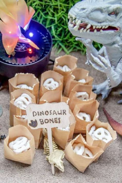 50 Roar-Worthy Dinosaur Party Ideas Your Kids Will Love 8 3 Rex Birthday Party Food Ideas, Dinosaur Treat Table Ideas, Dino Themed Treats, Cute Dinosaur Party Decorations, Dinosaur Bones Pretzels, Dino Food Party, T Rex Party Decorations, Dinosaur Themed Food Ideas, Dinosaur Birthday Party Foods