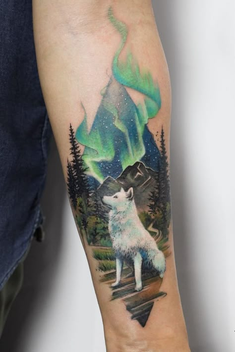 Thinking about your next tattoo? Let us help you find the right artist for the job. Download the app now ⚡️ #tattooinspo #tattoodesign #tattooart #tattooideas #tattooinspiration #tattooartist #wolf #wolftattoo #naturetattoo #landscapetattoo #wild #whitewolf #auroraborealis #spacetattoo #startattoo #tattooideasforwomen #smalltattoo #realismtattoo #deborahgenchi #forearmtattoo #colortattoo White Wolf Tattoo, Northern Lights Tattoo, Natur Tattoo Arm, Wolf Tattoos For Women, Wolf Tattoo Sleeve, Light Tattoo, Wolf Tattoo Design, Tattoos Geometric, Arrow Tattoo