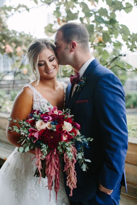 Rich blooms of burgundy and red are a beautiful choice for a cool weather wedding, don't you think? 😍 Not to mention it POPs next to a classic navy suit! Navy Pink Red Wedding, Berry And Navy Wedding, Bridal Bouquet Dark, Navy Winter Wedding, Navy Wedding Decorations, Bridal Bouquet Burgundy, Wedding Floral Bouquet, Rosewood Wedding, Navy And Burgundy Wedding