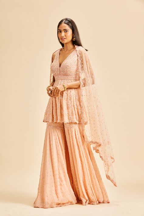 #NitikaGujral #Sharara #WeddingSharara #ShararaDesign #Weddingwear #Indianweddingwear Peach Sharara Suit, Peplum Sharara, Diwali Dress, Sequin Set, Georgette Sharara, Peach Color Dress, Diwali Dresses, Designing Clothes, Sharara Designs