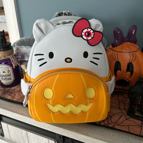 Loungefly Sanrio Hello Kitty Pumpkin Cosplay Scented Gitd Mini Backpack Exclusive Hey Pumpkin! Our Hello Kitty Pumpkin Cosplay Mini Backpack Is A Faux Leather With 3d Applique Ears, Printed Details, Embroidered Face Glitter Pvc Details Detail. Bag Has Padded Black Glitter Straps. Her Bow Has Her Halloween Eye That Glows In The Dark The Pumpkin Face Also Glows In The Dark. Not Only Is She Adorable But She Is Candy Scented! The Candy Molded Silicone Zipper Charm Is Candy Scented! And Her Arm And F Cute Halloween Accessories, Pumpkin Cosplay, Slay Funny, Sanrio Loungefly, Halloween Backpack, Kitty Pumpkin, Up Carl And Ellie, Hello Kitty Pumpkin, Dream Accessories