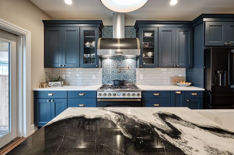 This kitchen in Fishtown, Philadelphia features Sherwin Williams rainstorm blue painted perimeter cabinets with Namib white quartzite countertop. An oak island with panda quartzite countertop includes apron front sink, trash pull out and open display cabinet. Brass hardware accents and black appliances are also featured throughout the kitchen. Blue Kitchen Black Appliances, Blue Kitchen Cabinets Black Appliances, Vermont Kitchen, Built In Microwave Cabinet, Nautical Office, Fishtown Philadelphia, Green Bedrooms, Corner Base Cabinet, White Quartzite