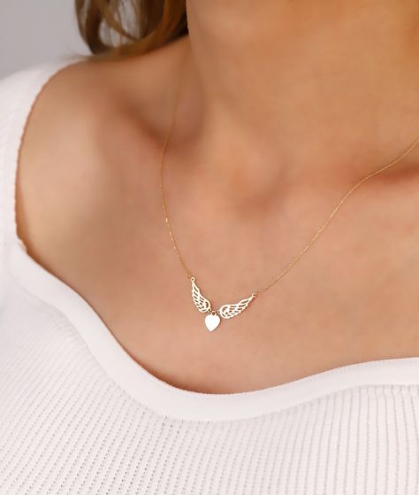 "This winged heart necklace gift will make your soulmate very happy. It is real solid gold so it can be used everyday without removing it. * Pendant height: 15 mm * Pendant width: 30 mm * The thickness of the cable chain is 1 mm. * At the time of purchase, you can choose the chain length as 16\" (40 cm), 18\" (45 cm), 20\" (50 cm), 22\" (55 cm) or 24\" (60 cm). * The length of the chain used in the photo is 18 inches. * You can choose one of the colors yellow gold, white gold or rose gold. The color of the necklace used in the photos is yellow gold. * Temiroglu Gold products are real solid gold. It is definitely not gold plated, not gold filled. * All products are presented to you in high quality jewelry boxes. * Depending on your request, we can provide delivery in the form of a gift pack Soulmate Necklace, Flying Heart, Angel Wings Necklace, Angel Pendant Necklace, Winged Heart, Wings Necklace, Feminine Necklace, Gold Angel Wings, Angel Wing Necklace