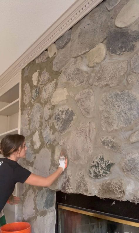 Melissa Tyler applying mortar to her fireplace stones with gloved hands. Tile Inside Of Fireplace, Stone Fireplace With Painted Mantle, Stone Fireplace With Insert, Remodel Rock Fireplace, Stone Fireplace White Grout, German Smear River Rock Fireplace, How To Overgrout Stone Fireplace, Over Grout Stone Fireplace, Grouting Stone Fireplace