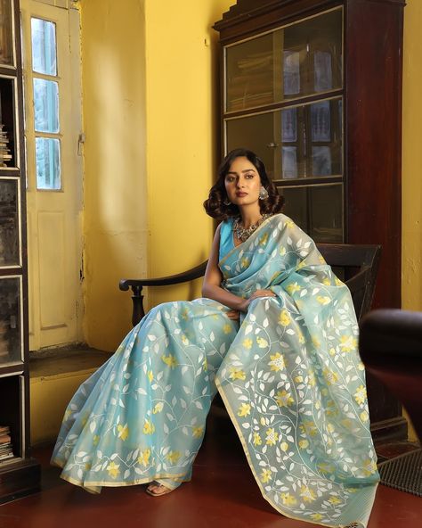 PRICE INR 50,000 अनुराधा - कहानी जामदानी की! The beauty of Muslin silk Jamdani sarees lies in the traditional craftsmanship that goes into their creation. Each saree is a labor of love, with skilled artisans dedicating hours to weaving intricate patterns by hand, ensuring a unique and timeless piece of art. [Luxury textile, Indian Textile, Kapaaskatha, Bengal weave, Jamdani, Story of India, Support artisans] This is a Blue Muslin Silk Jamdani Saree with beautiful flowers. The saree comes wi... Jamdani Blouse Designs, Muslin Saree, Luxury Textiles, Jamdani Saree, Indian Textiles, Intricate Patterns, Fashion Sewing, Timeless Pieces, Blouse Designs