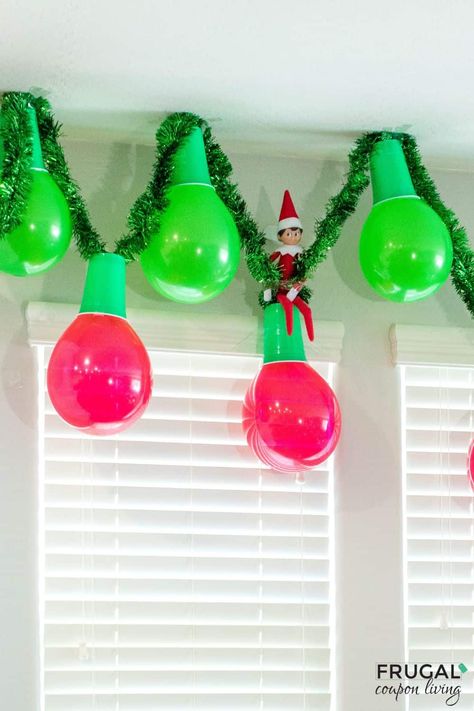 Make an adorable Christmas garland out of balloons and plastic cups in a few simple steps. Enjoy this Elf on the Shelf Balloon Garland and Elf on the Shelf Balloon ideas. This DIY balloon garland idea is quite adorable and adds instant Christmas decor to your cute elf idea. New Elf on the Shelf ideas daily plus free Elf on the Shelf printables. #FrugalCouponLiving #ElfontheShelf Elf On The Shelf In Balloon Ideas, Elf On The Shelf Ornaments Diy, Elf On Shelf In Balloon, Willy Wonka Elf On The Shelf, Elf Inside A Balloon, Elf On Shelf Decorating Christmas Tree, Elf On The Shelf With Balloons, Elf Ballerina Ideas, Elf On The Shelf Christmas In July