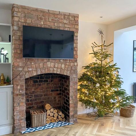 Sarah on Instagram: "Transformation Tuesday Christmas tree number 2 taking pride of place in the kitchen/family room beside the exposed chimney breast I regret not taking more before pictures of this room but if you swipe across, you’ll see a ‘during’ picture when we’d started to pull the plaster back, exposing this beautiful arch. A lot of graft by ourselves later and we’re super happy with the outcome A little secret I’ll share (& before you ask what colour it is), but this room is still Exposed Brick Fireplace Dining Room, Log Burner No Chimney Breast, Exposed Chimney Living Room, Dining Room With Brick Fireplace, Exposed Brick Chimney Breast, Chimney Breast Decor, Exposed Brick Walls Living Room, Exposed Chimney, Chimney Breast Ideas