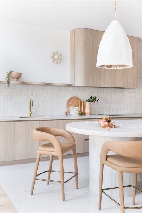 A bright white, open plan kitchen features curved details throughout with brushed brass accents. Beach Vibe House, Curved Kitchen Islands, Modern Family Kitchen, Curved Island, Modern Kitchen Renovation, Curved Kitchen, Interior Studio, Integrated Fridge, Family Kitchen