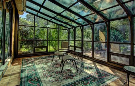 Enclosed back patio with glass windows and Spanish tile floors Screened In Porch With Glass Roof, Enclosed Patio Greenhouse, Sunroom Designs Modern, Enclosed Patio Ideas On A Budget, Glass Patio Enclosure, Glass Enclosed Patio, Patio Rooms Enclosed Sunroom Ideas, Greenhouse Floor Ideas, Enclosed Back Patio