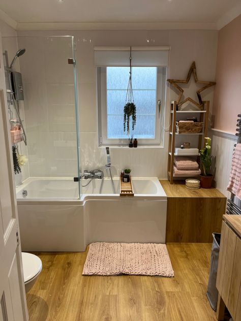 L shaped bath from Wickes, shelving from B&q, flooring b&q quickstep paso in warm oak, tiles also b&q and have a slight wave through them B&q Bathroom, Pink Bath Panel, J Shaped Bath, L Shape Bath, Pale Pink Tiles Bathroom, L Shaped Bath, P Shaped Bath, Quickstep, Pink Bathroom