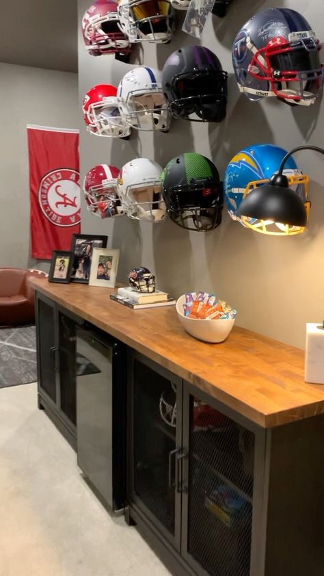 Kara de Oliveira (@kdo.interiors) posted on Instagram • May 5, 2022 at 6:34pm UTC Helmet Display Ideas Man Cave, Nfl Helmet Display Ideas, Sports Themed Office, Home Movie Room, Attic Man Cave, Sports Display, Landry Room, Sports Man Cave, Cave Design