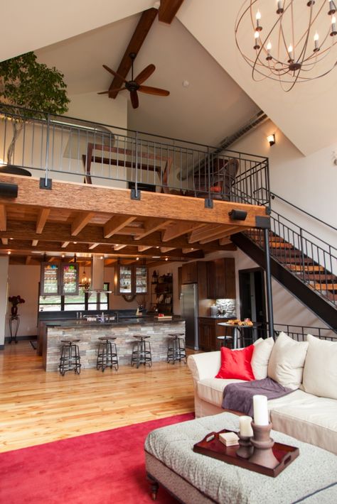 Stairs In Center Of Living Room, Loft Over Kitchen Ideas, Farm Loft House Design, Loft Above Kitchen Ideas, Loft Above Dining Room, Four Bedroom Barndominium Plans With Loft, Open Plan Kitchen Dining Living With Stairs, Balcony Over Kitchen, Loft Over Kitchen High Ceilings