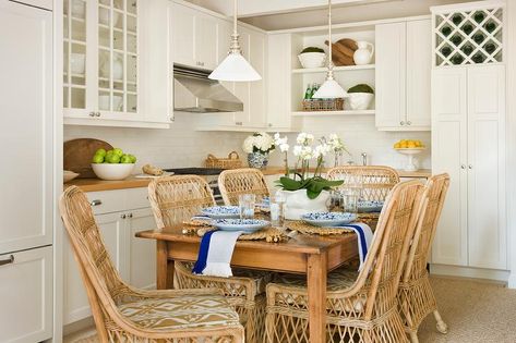 This small white eat-in kitchen features wicker dining chairs placed around a wooden dining table illuminated by vintage white pendants. Sarah Bartholomew Designs, Sarah Bartholomew, Breakfast Rooms, Chairs Vintage, Online Interior Design Services, The Enchanted Home, Enchanted Home, Brown Furniture, Dining Areas