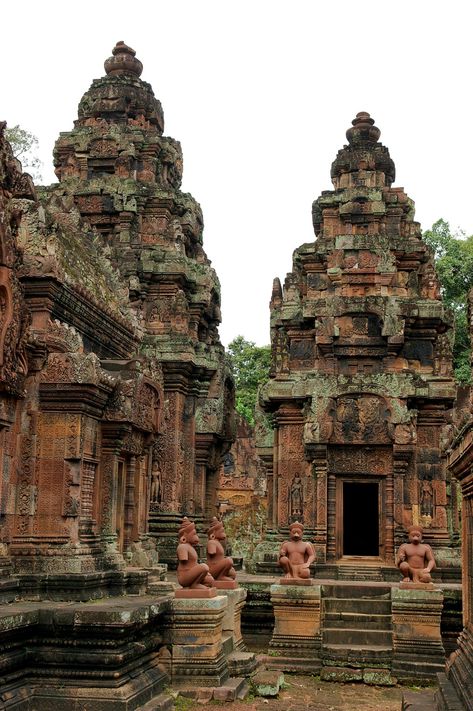 Banteay Srei (Banteay Srey)a 10th c.temple of Khmer architecture dedicated to the Hindu god Shiva.Angkor in Cambodia,25 km north-east of the main group of temples that once belonged to the medieval capitals of Yasodharapura&Angkor Thom.Angkor-the region of Cambodia serving as the seat of the Khmer empire that flourished from c.the 9th c.to the 15th c.The temples of the Angkor area number over 1000. Jungle Temple, Cambodian Art, Khmer Empire, Jungle Vibes, Breathtaking Places, Church Architecture, Hindu Temple, The Ruins, Angkor Wat