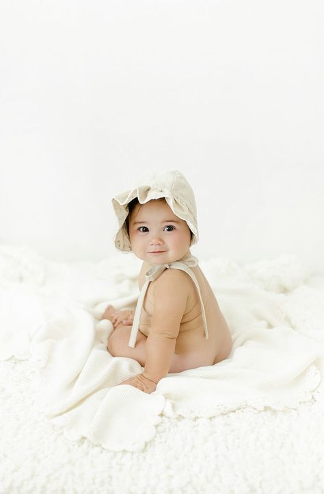 Smiling baby girl with dark hair wearing a bonnet sitting on a blanket 6 Month Girl Photoshooting, Girl 6 Month Shoot, 6 Month Studio Photoshoot, Baby Girl 6 Months Shoot, Six Month Baby Photoshoot, 8 Month Old Photoshoot, 10 Months Baby Photography, 6 Months Baby Photoshoot, 6 Month Old Photoshoot