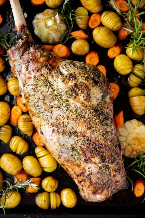 Roasting a leg of lamb in the oven is so easy! Seasoned with a garlic herb butter and roasted with potatoes and carrots, it's the perfect classic Easter dinner recipe. | #easterdinner #eastercooking #easterrecipes #lambrecipes #sundayroast Slow Oven Roasted Leg Of Lamb, Roast Lamb Recipes Ovens, Lamb Leg Roast Recipes Ovens, Roast Leg Of Lamb Bone In Recipe, How To Cook Leg Of Lamb In Oven, Roast Lamb Leg Recipes, Lamb Roast Recipes Ovens, Leg Of Lamb Side Dishes, Leg Of Lamb Recipes Bone In Ovens