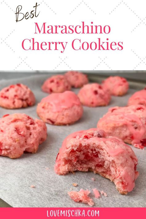 Pink cherry cookies on parchment paper. The closest one has a bite taken out of it to reveal bright red pieces of maraschino cherry and a moist, soft center. Cherry Maraschino Cookies, Recipes Using Cherry Juice, Cheery Cherry Cookies, Chewy Cherry Cookies, Cherry Italian Cookies, Glazed Cherry Recipes, Cherry Wedding Cookies, Christmas Cookies With Maraschino Cherries, Cherry Nut Cookies