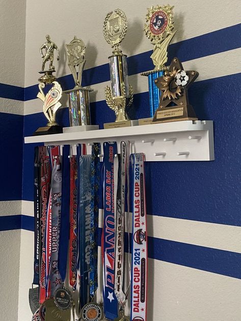 How To Display Sports Medals, Volleyball Medal Display Ideas, Trophy Medal Shelf, Medal Stand Display, Soccer Memorabilia Display, Hang Medals Ideas, Sports Metal Display Ideas, Medal Hanging Ideas, Medal Trophy Display Ideas