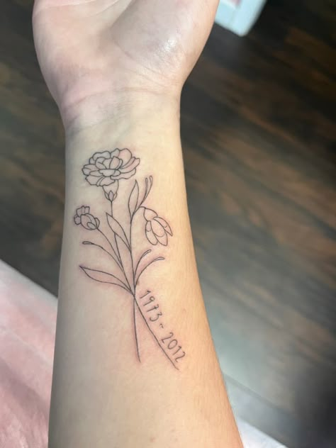 Bouquet Of Flowers Drawn By Family Tattoo, May And March Birth Flower Tattoo, Carnation Memorial Tattoo, Birth Flower Memorial Tattoo, Flower With Date Tattoo, Rose Tattoo With Date, January Birth Flower Tattoo Ideas, Birth Date Tattoos For Women, Flower Memorial Tattoo