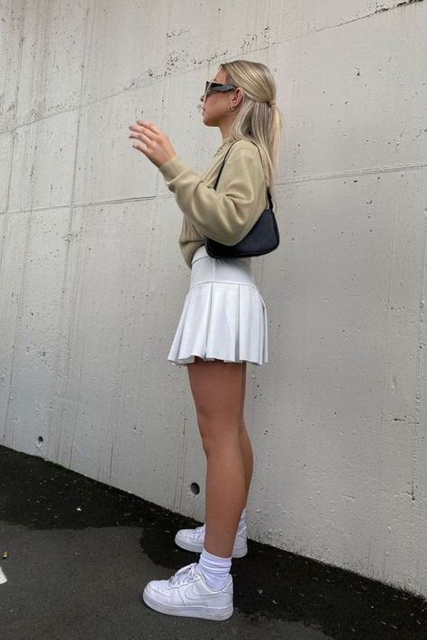 6 Cute White Tennis Skirt Outfit Ideas White Tennis Skirt Outfit Ideas, White Tennis Skirt Outfit Street Style, White Tennis Skirt Outfit Summer, Tenis Skirt Outfits, Tennis Skirt And Sweatshirt, Tennis Skirt Outfit Ideas, Style A Tennis Skirt, How To Style A Tennis Skirt, Tennis Skirt Outfit Summer