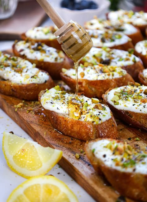 Truffle Pistachio Whipped Ricotta Crostini High Tea Appetizers, Cocktail Hour Snacks, Friendsgiving Recipes, Ricotta Crostini, Ricotta Dip, Crostini Appetizers, Whipped Ricotta, Friendsgiving Food, Gourmet Appetizers