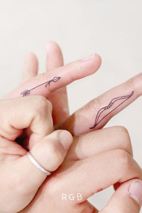 Matching Finger Arrow And Bow Tattoos #matchingtattoos #arrowtattoo Arrow And Bow, Arrow Tattoo Finger, Unique Tattoos Black Women, Bow Tattoos, Cool Finger Tattoos, Couple Matching Tattoo, Ring Finger Tattoos, Bow Tattoo, Ring Tattoos