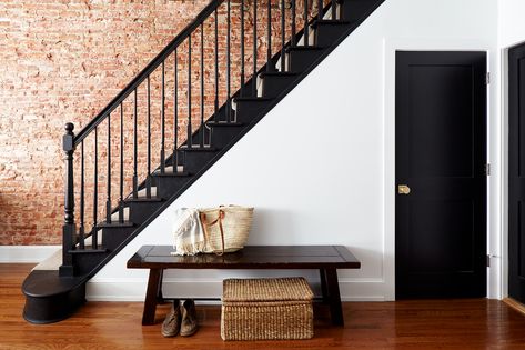 Stairwell with exposed brick wall. Black painted doors, treads, risers, and railing. Exposed Brick Stairwell, Staircase Wallpaper Ideas, Stairs Wall Decor Ideas, Stairs Wall Decor, Staircase Wall Design, Classic Staircase, Stairwell Ideas, Transitional Staircase, Coastal Paint Colors