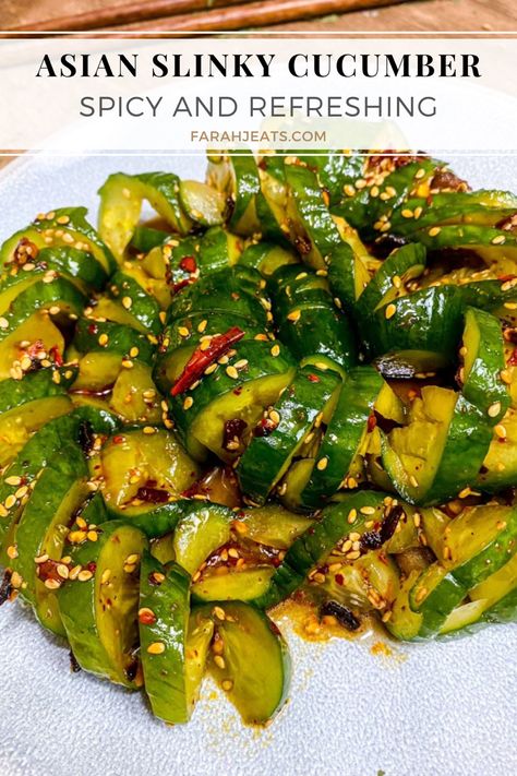 Spicy Asian Slinky Cucumber Salad served on a white plate. Crunchy Asian Cucumber Salad, Cucumber Noodles Recipes, Curly Cucumber Salad, Crunchy Cucumber Salad, Chinese Cucumber Salad Recipe, Cucumbers With A Bang, Leftover Cucumbers, Viral Cucumber Salad, Spiral Cucumber Salad