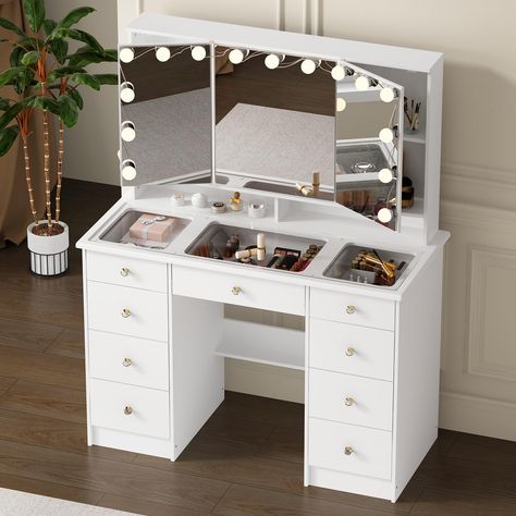 PRICES MAY VARY. Tri-Fold Mirror with LED Lighting: The vanity desk features a large tri-fold mirror with adjustable LED bulbs, offering three color settings (white, neutral, warm) and brightness adjustable for optimal lighting during your makeup routine Generous Storage Capacity: The makeup table comes with 9 spacious drawers, providing ample space to organize all your makeup, brushes, and beauty accessories. There also have hidden shelves behind mirrors, keeping your vanity clutter-free Sleek Vanity Desk Aesthetic, Vanity Amazon, Makeup Vanity With Lights, Vanity With Lights, Makeup Vanity Ideas Bedrooms, Vanity Inspo, Vanity Inspiration, Desk Vanity, Beauty Room Vanity