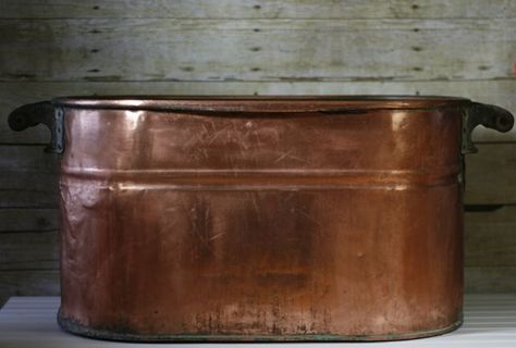 I inherited an antique copper boiler/wash tub when I was in my early 20's. It had an amazing patina but for years I wanted to polish it to see what was hidden beneath the surface. I tried so many different products but nothing worked until one day, I tried something that I thought would never work but it did, like magic!    Here is a view of the copper boiler before I attempted to clean it. It's dented and well-used but I love it. It was my father's mother's and she used it to wash cl… Copper Bucket Decor Ideas, Clean Copper, Farmhouse Headboard, Diy Candle Sticks, Mason Jar Storage, How To Clean Copper, Antique Dining Chairs, Copper Tea Kettle, Copper Tub