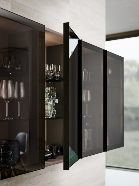 A finely crafted aluminium frame meticulously assembled with the glass panel creates an exclusive and refined accessory.

The new glass doors feature a smoked glass panel set in a black anodised aluminium frame with an integrated pull on one side running along the full height of the door.

The range of available modules provides glass door solutions for wall, base and tall units. Black Glass Cabinet, Luxury Room Design, Glass Kitchen Cabinets, Cabinet Glass Doors, Industrial Kitchen Design, Modern Kitchen Cabinet Design, Modern Kitchen Cabinets, Glass Cabinet Doors, Kitchen Room Design