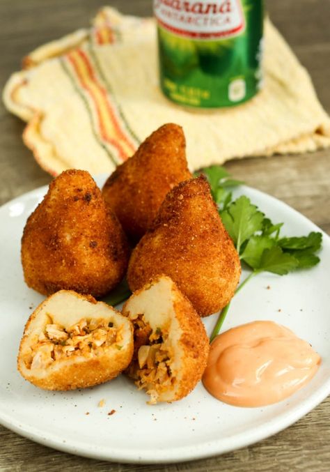 Coxinha recipe video – scroll down for recipe. Coxinha (pron: co-SHEEN-ya) is a Brazilian street food, minced chicken wrapped in a soft dough, breaded and deep fried. Is there any part of that that doesn’t sound completely great? I’ll answer. There’s not! Coxinha Recipe, Brazilian Chicken, Chicken Croquettes, Brazilian Food, Cooking Show, Chicken Seasoning, Easy Cooking, Street Food, Food Videos