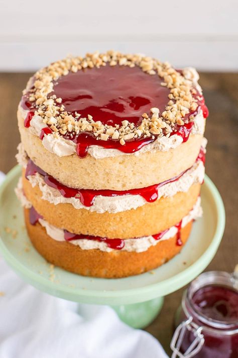 Peanut butter cake layers and frosting paired with your favourite jam. This Peanut Butter & Jelly Cake is a childhood flashback in the best way possible! | livforcake.com Peanut Butter And Jelly Cake Recipe, Peanut Butter Jelly Cake, Peanut Butter And Jelly Cake, Dessert Flavors, Minimal Cake, Jelly Cakes, Raspberry Jelly, Cake Style, Sweet Time